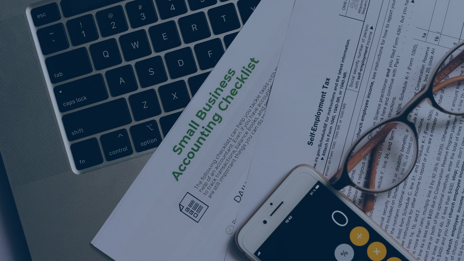 Desk with laptop, invoices and financial documents for electronic invoicing and myDATA